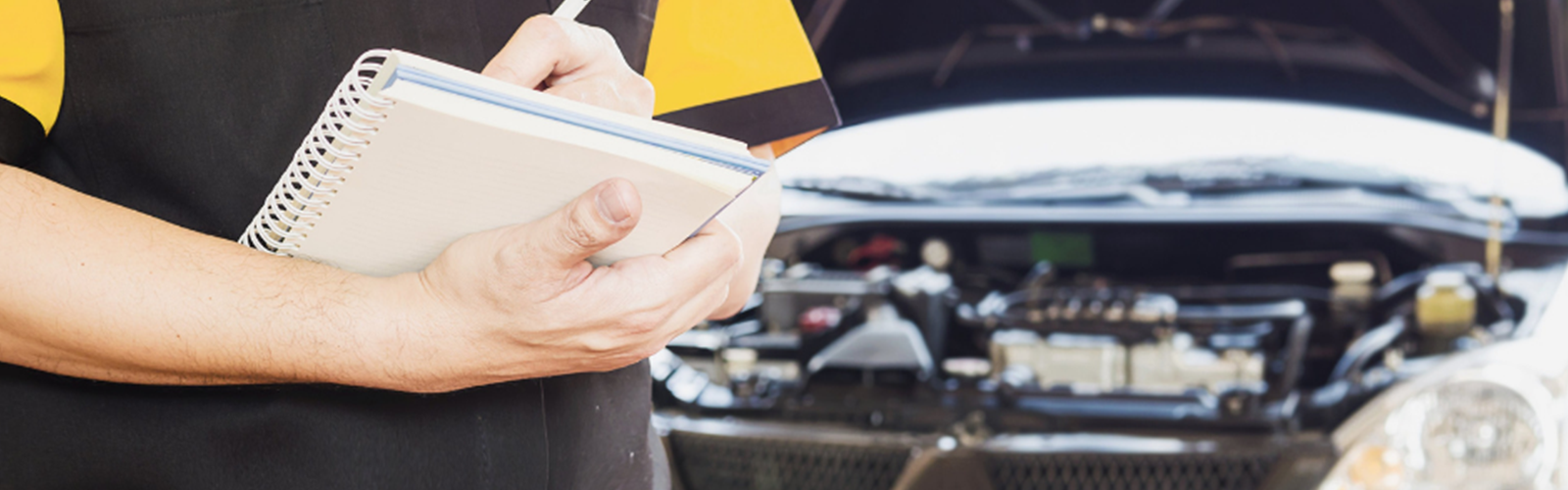 A mechanic writing up a car repair bill