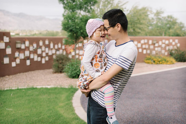 A father holding his daughter